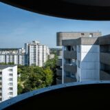 the view from the window of a building shows a city