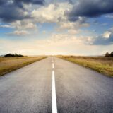 asphalt road under cloudy sky