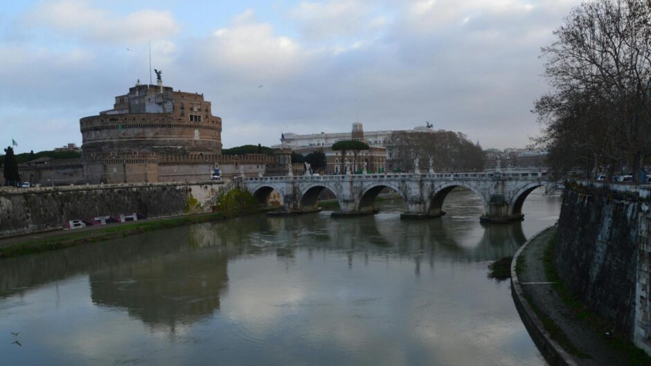 buildings and bridge reflected in river